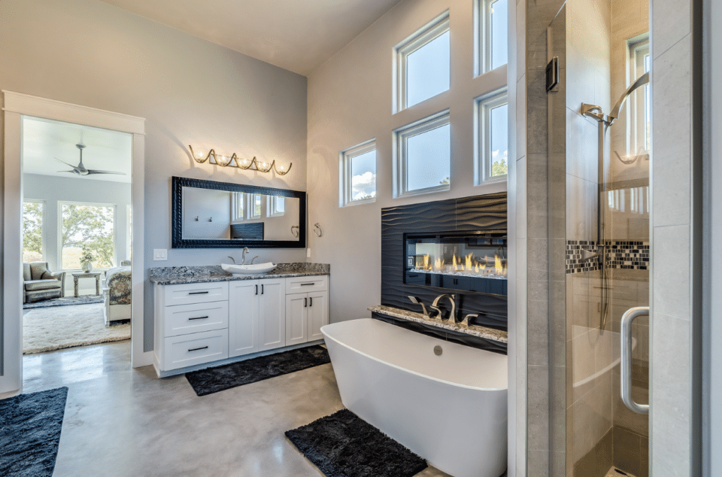master bathroom with a fireplace above tub
